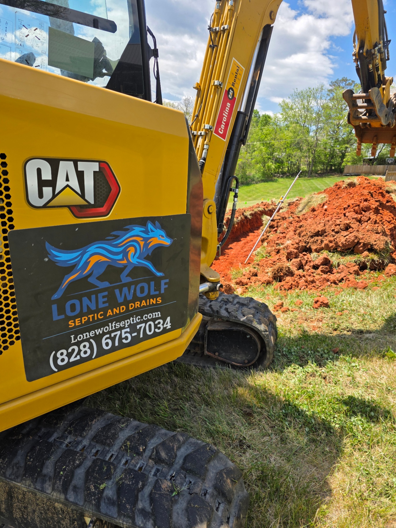 Lone Wolf Septic CAT excavator on a job site in Western NC